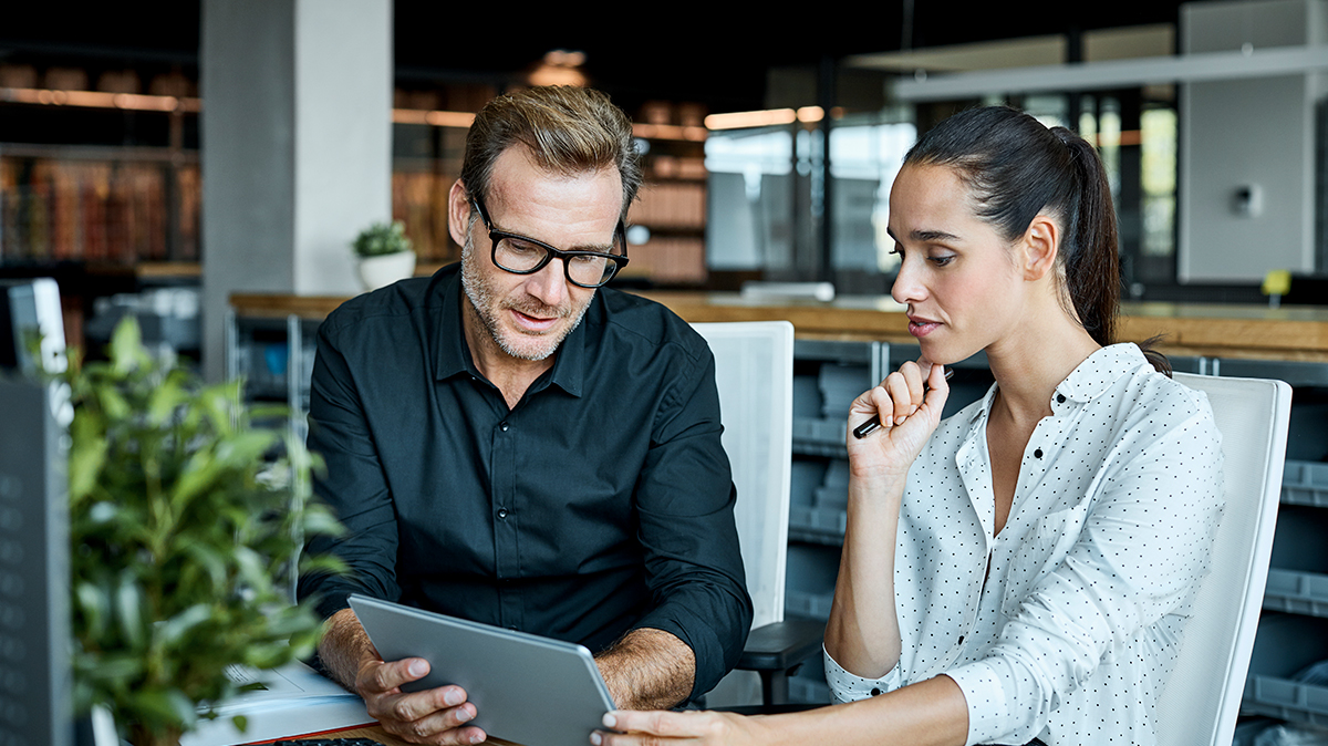 Two people looking at tablet